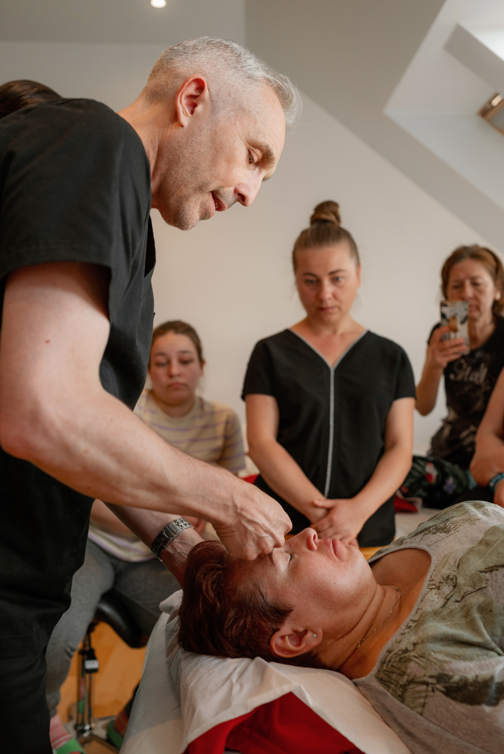 Clive Witham demonstrating Facial Gua sha during an in-person class